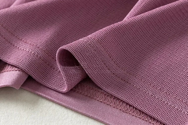 Detailed stitching and textures fabric on the bottom of a Women's dual-layer silk top in Lily color. From Borcelleclothes.