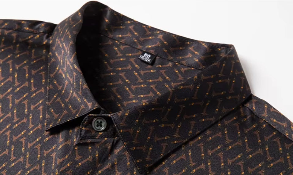 Detailed stitching and textured fabric on the collar of the Men's Mulberry silk shirt in English Walnut featuring a unique geometric design with intricate rhombuses and vibrant orange accents. The shirt combines luxurious fabric with refined elegance, perfect for a sophisticated look. From Borcelleclothes.