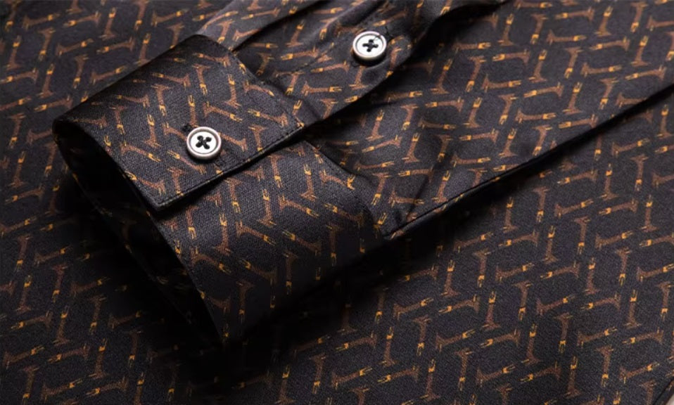 Detailed stitching and textured fabric on the cuff with buttons of the Men's Mulberry silk shirt in English Walnut featuring a unique geometric design with intricate rhombuses and vibrant orange accents. The shirt combines luxurious fabric with refined elegance, perfect for a sophisticated look. From Borcelleclothes.