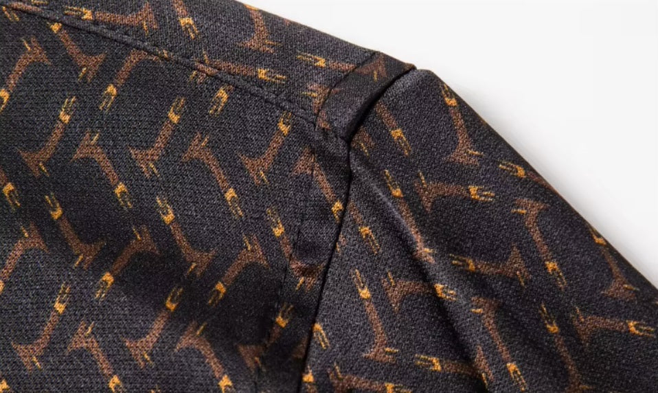 Detailed stitching and textured fabric on the shoulder of the Men's Mulberry silk shirt in English Walnut featuring a unique geometric design with intricate rhombuses and vibrant orange accents. The shirt combines luxurious fabric with refined elegance, perfect for a sophisticated look. From Borcelleclothes.