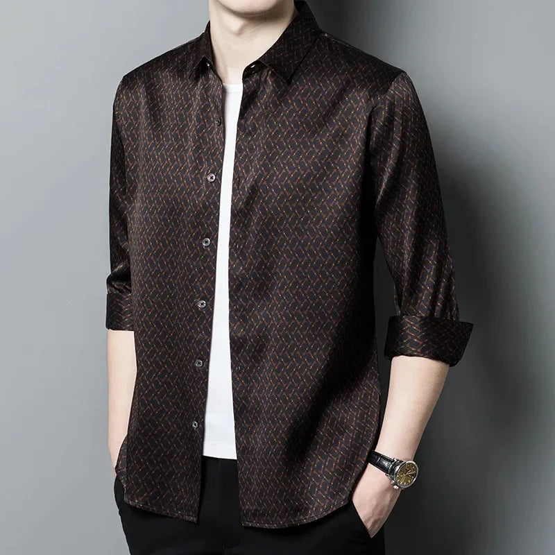 Model wearing an unbuttoned men's Mulberry silk shirt in English Walnut, showcasing the geometric design with intricate rhombuses and vibrant orange accents, highlighting the relaxed yet elegant fit. From Borcelleclothes.