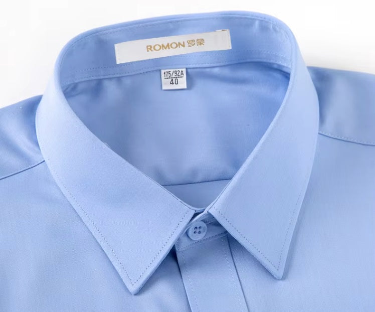 Detailed stitching and textured fabric on the collar of the Men's 100% Mulberry silk shirt in solid Tropical Blue, featuring a pointed collar, single-breasted front, and a modern tailored silhouette. The shirt offers comfort, elegance, and a smooth, breathable texture. From Borcelleclothes.
