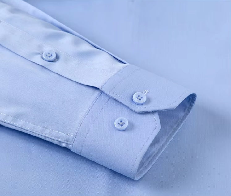 Detailed stitching and textured fabric on the cuff with buttons of the Men's 100% Mulberry silk shirt in solid Tropical Blue, featuring a pointed collar, single-breasted front, and a modern tailored silhouette. The shirt offers comfort, elegance, and a smooth, breathable texture. From Borcelleclothes.