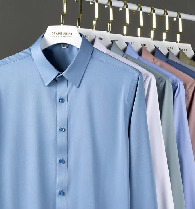 Collection of men's 100% Mulberry silk shirts in solid colors, featuring a modern tailored silhouette, pointed collar, and single-breasted design. The shirts offer comfort, elegance, and a smooth, breathable texture. From Borcelleclothes.