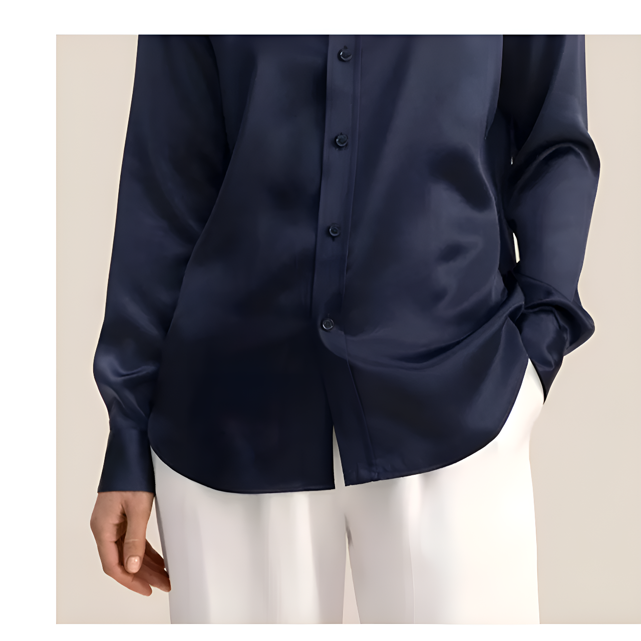 Detailed stitching and textured fabric on the part of the placket and the bottom of a Women's Business Midweight Satin Silk Shirt in Onyx, crafted from 100% Mulberry silk with a luxurious midweight satin finish. The shirt showcases a smooth, lustrous texture that offers elegance and sophistication, ideal for formal and professional settings. From Borcelleclothes.