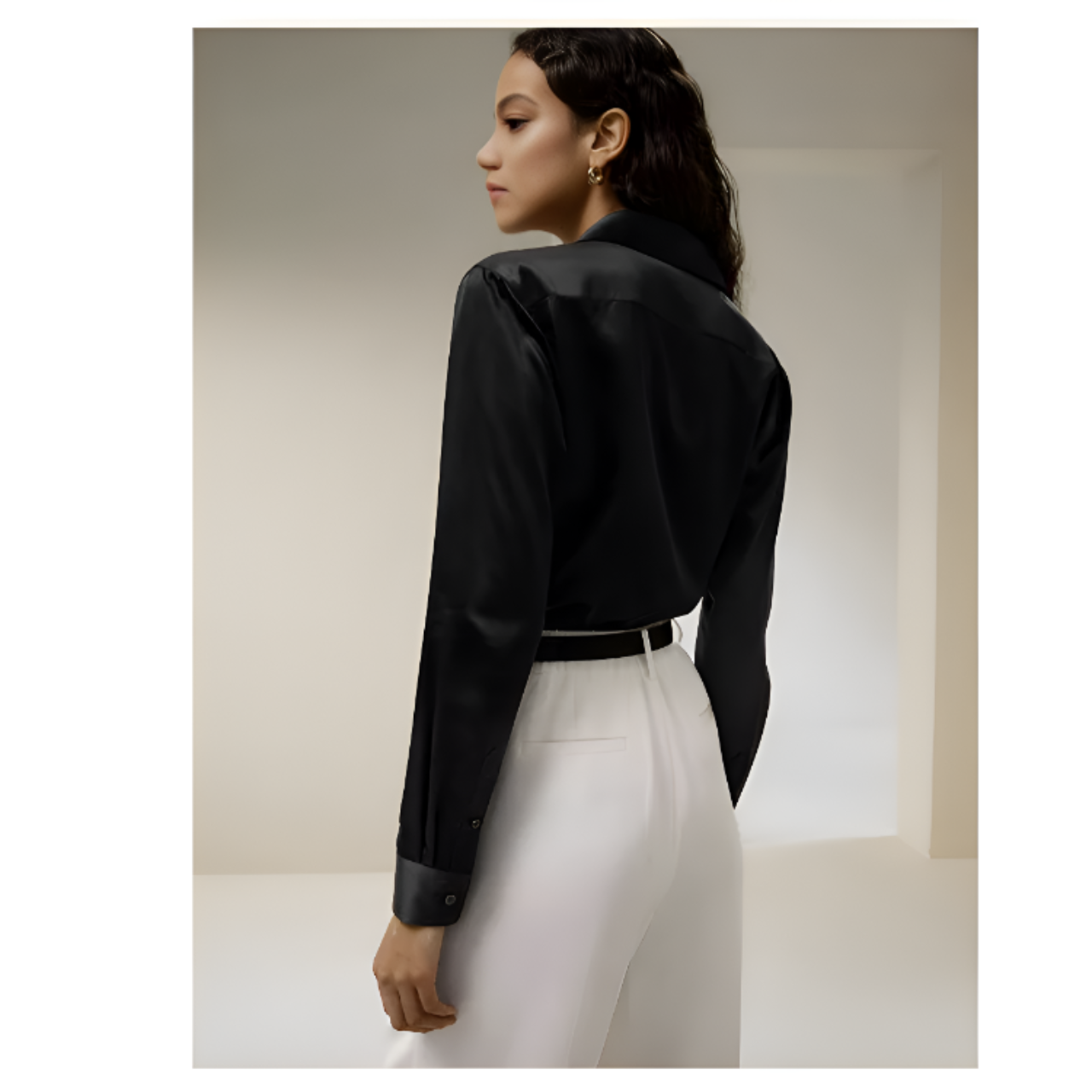 The back of a Women's Business Midweight Satin Silk Shirt in Onyx, crafted from 100% Mulberry silk with a luxurious midweight satin finish. The shirt showcases a smooth, lustrous texture that offers elegance and sophistication, ideal for formal and professional settings. From Borcelleclothes.