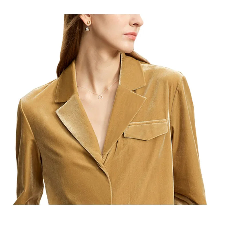 Detailed stitching and textured fabric on the notched collar and flap pocket of a Women's Silk Velvet Shirt in Camel, crafted from a luxurious silk and viscose blend. Featuring a soft gloss, breathability, a notched collar, single-breasted closure, and left-side flap pocket, this health-conscious velvet shirt offers elegance and comfort for professional and casual wear. From Borcelleclothes.