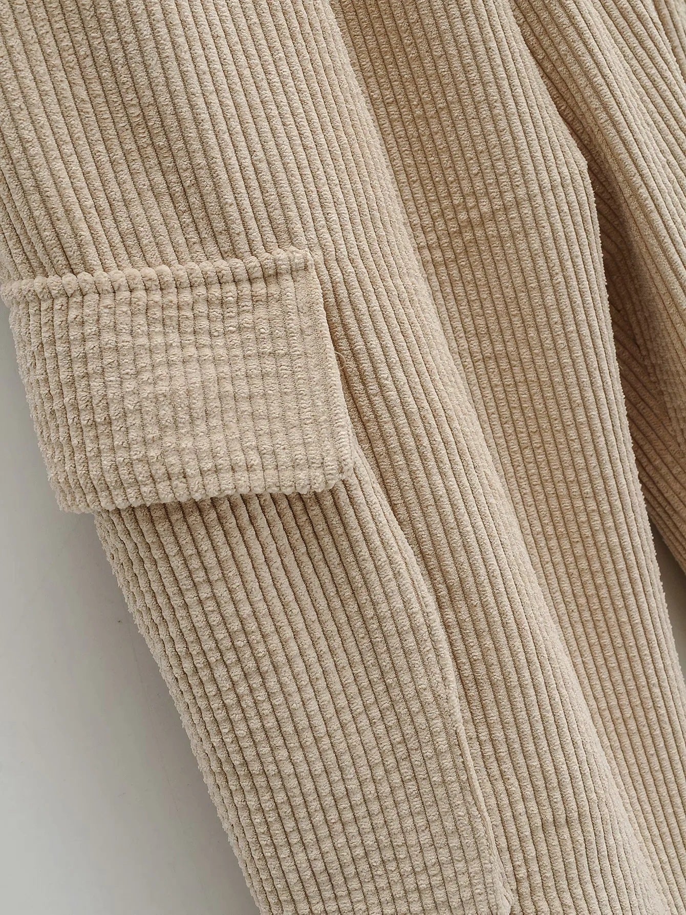 Detailed stitching and textured fabric on the side pocket of Women's Wide Wale Corduroy Sweatpants in Coral Reef, designed with elastic cuffs and waistband for a relaxed, stylish fit. From Borcelleclothes.