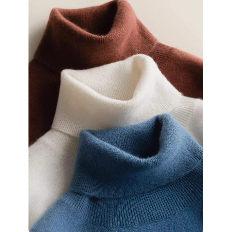 Alashan cashmere turtleneck sweaters in three different colors, overlapping in an arranged display to showcase their soft texture and elegant colors, Borcelleclothes.