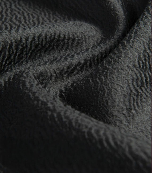 Close-up of Onyx cashmere fabric showing texture and composition. From Borcelleclothes.