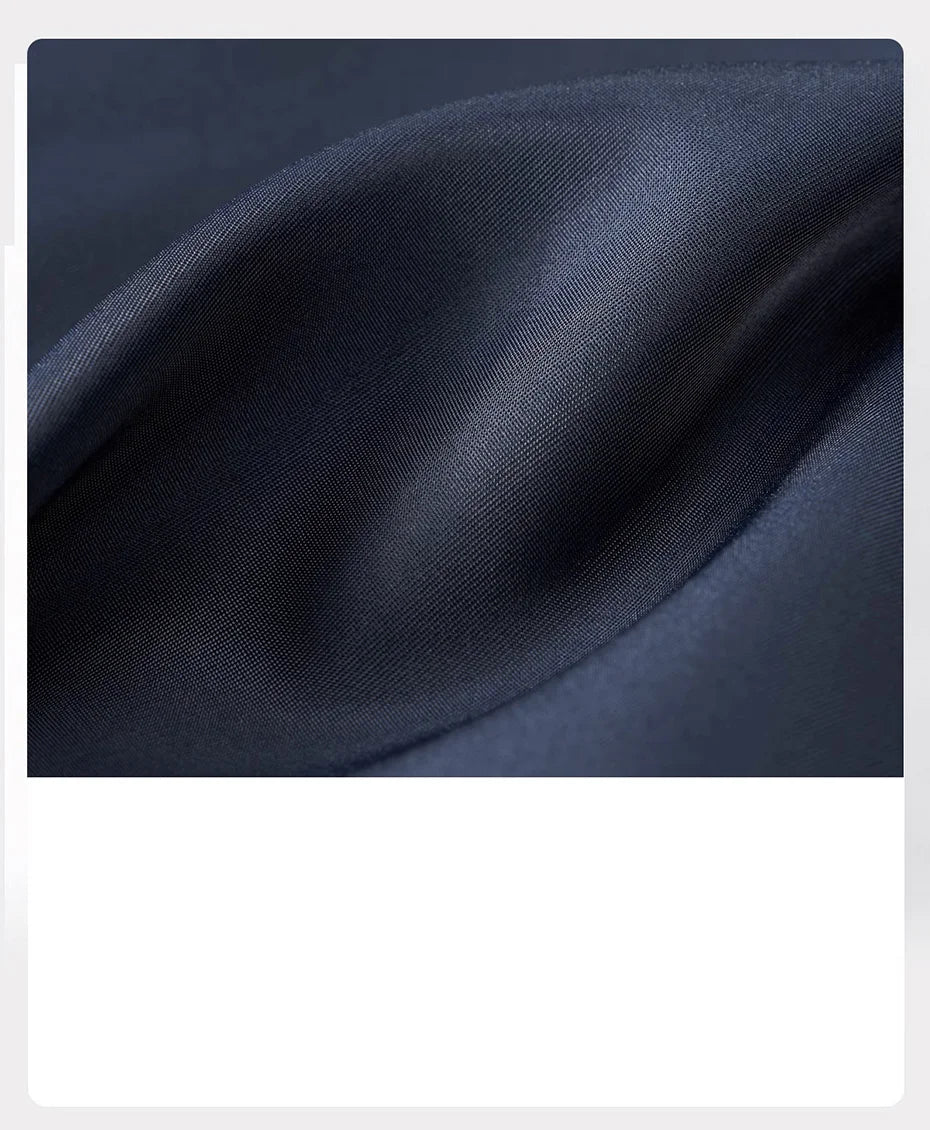 Ebony Clay wool-blend fabric folded in soft waves — structured yet flexible. From Borcelleclothes.