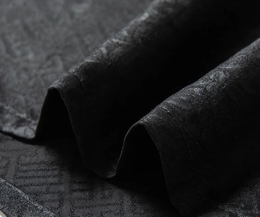 Macro shot of the flat, stable bottom hem of the men's Beyond Mistletoe shirt-jacket, showcasing the clean industrial finishing that prevents the silk from sagging over time. — From Borcelleclothes.