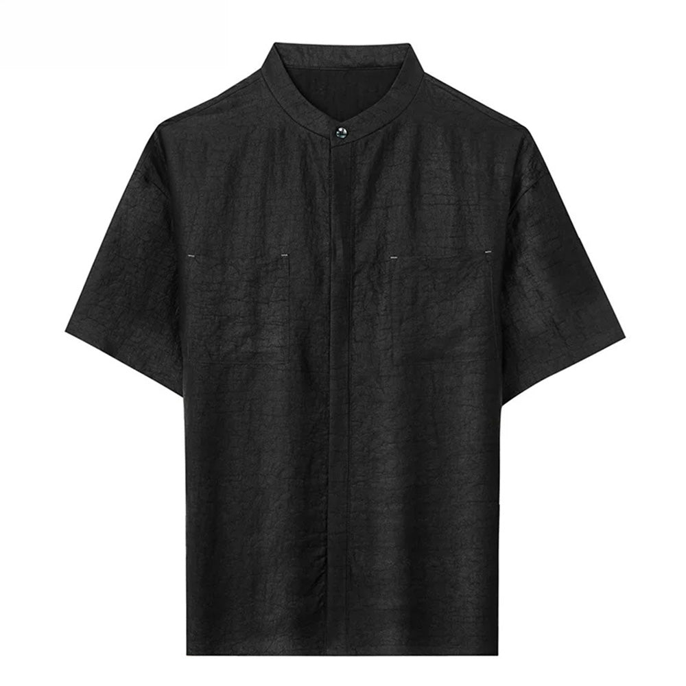 Detail shot of the front draping and concealed placket on a fluid, mineral-fermented black silk shirt. From Borcelleclothes.