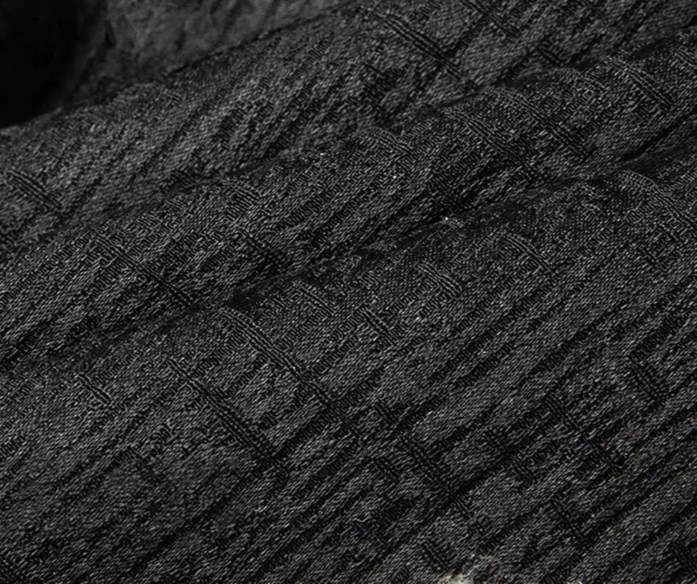 Macro shot of the 100% Mulberry silk jacquard surface, detailing the intricate factory weave alternating glossy graphite and matte threads to recreate deep lines and micro-creases - From Borcelleclothes.