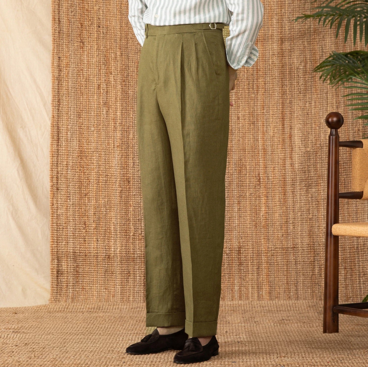 Model in Shadow trousers with hands behind back, accentuating quiet confidence and clean tailoring. From Borcelleclothes.