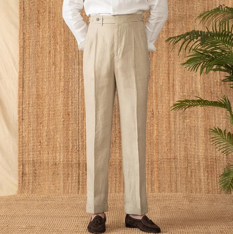 Model standing with arms behind back in Soft Amber trousers, showcasing fluid linen drape and natural structure. From Borcelleclothes.