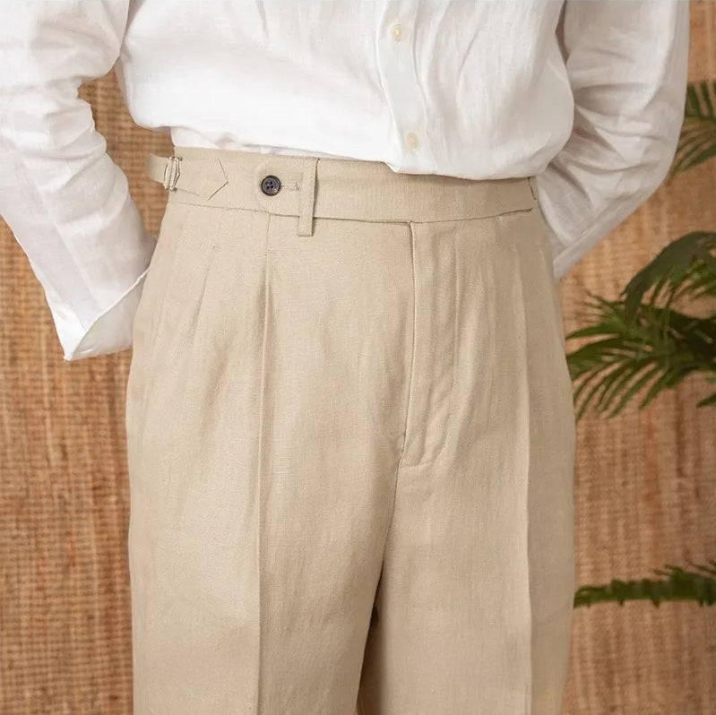 Model with hands behind back wearing linen trousers in Soft Amber, emphasizing clean silhouette and tailoring. From Borcelleclothes.