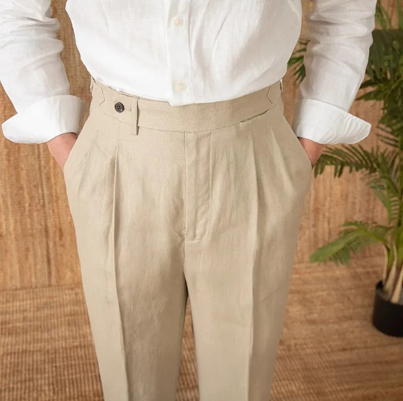 Upper body view of model with hands in pockets, wearing linen trousers in Soft Amber; highlights fabric texture and front structure. From Borcelleclothes.