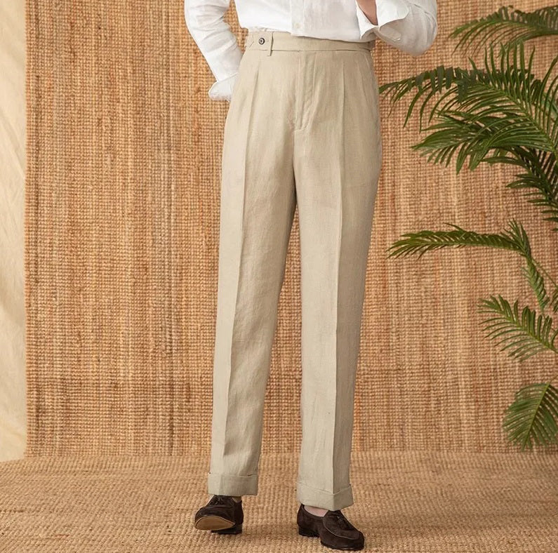 Model wearing Soft Amber trousers with right foot lifted at heel, capturing relaxed stance and fabric movement. From Borcelleclothes.