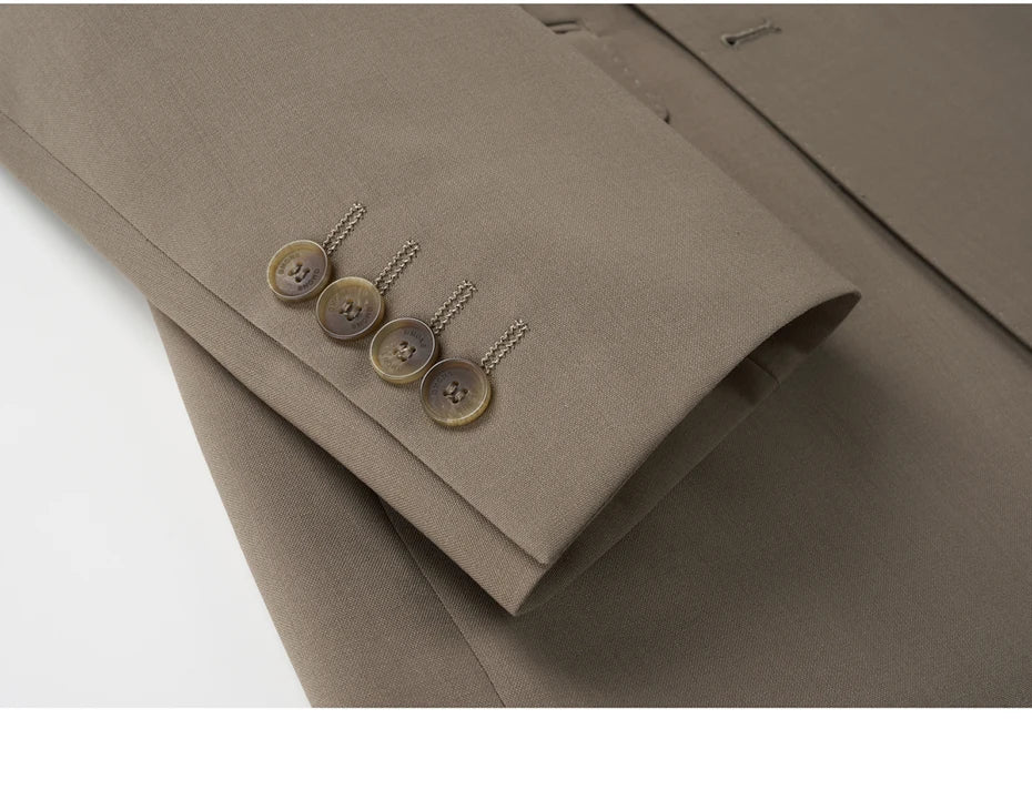 Detail of blazer sleeve with horn buttons and decorative buttonholes in Almond Frost. From Borcelleclothes.