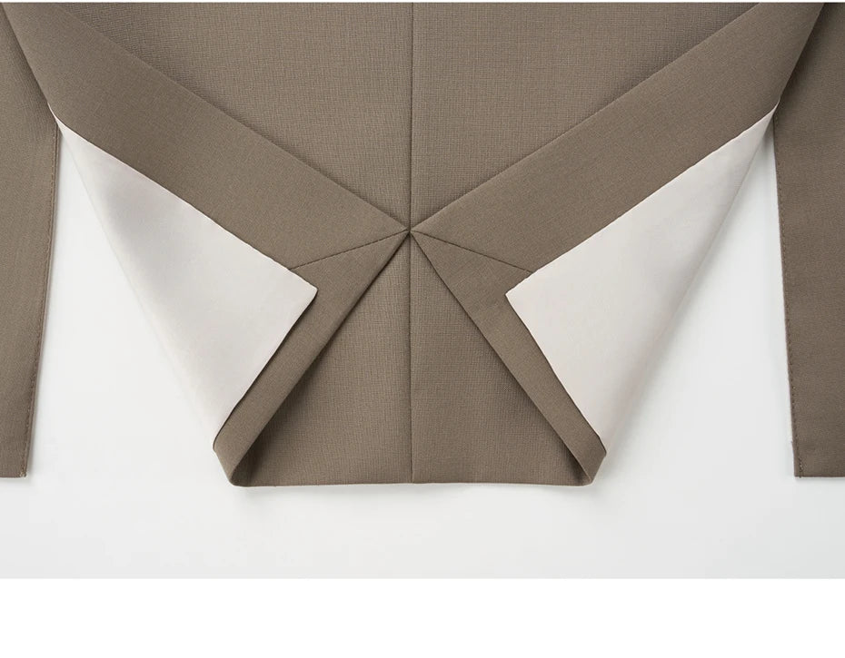 Blazer in Almond Frost laid flat with unfolded hem, revealing clean finishing. From Borcelleclothes.