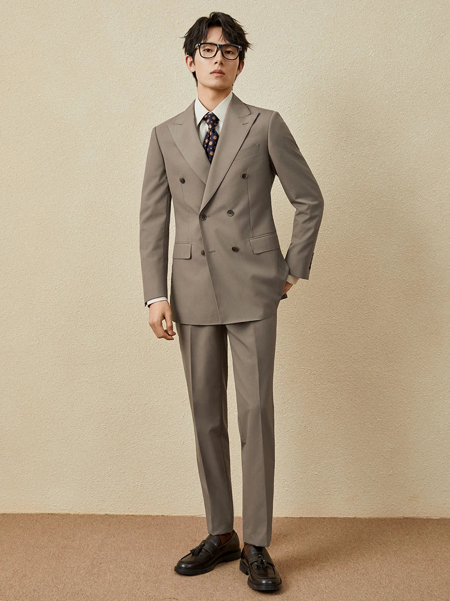 Model wearing the Almond Frost double-breasted suit with one hand in the pants pocket, radiating quiet confidence. From Borcelleclothes.