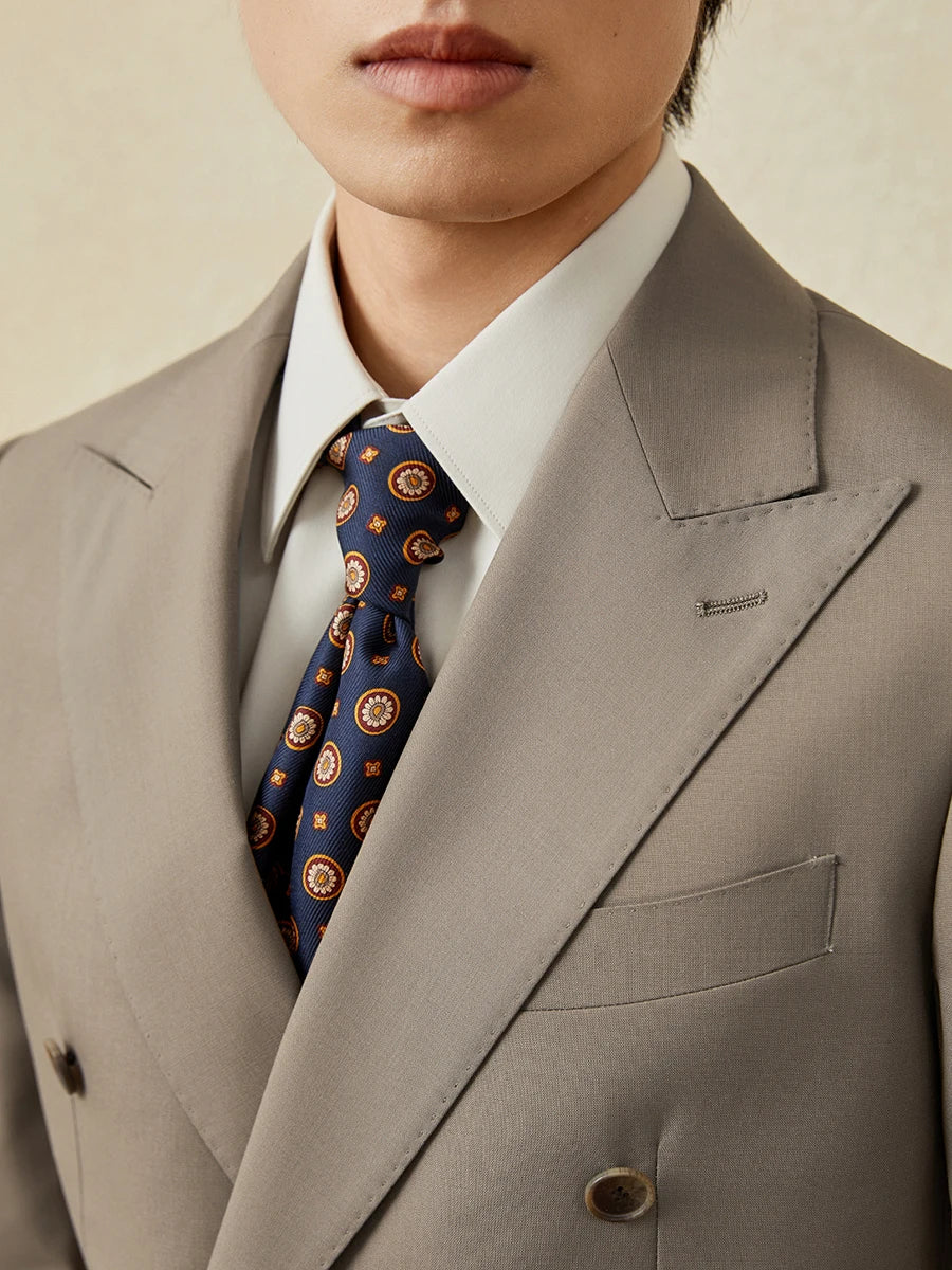 Upper view of the Almond Frost suit on model, showing peaked lapels and tailored silhouette. From Borcelleclothes.
