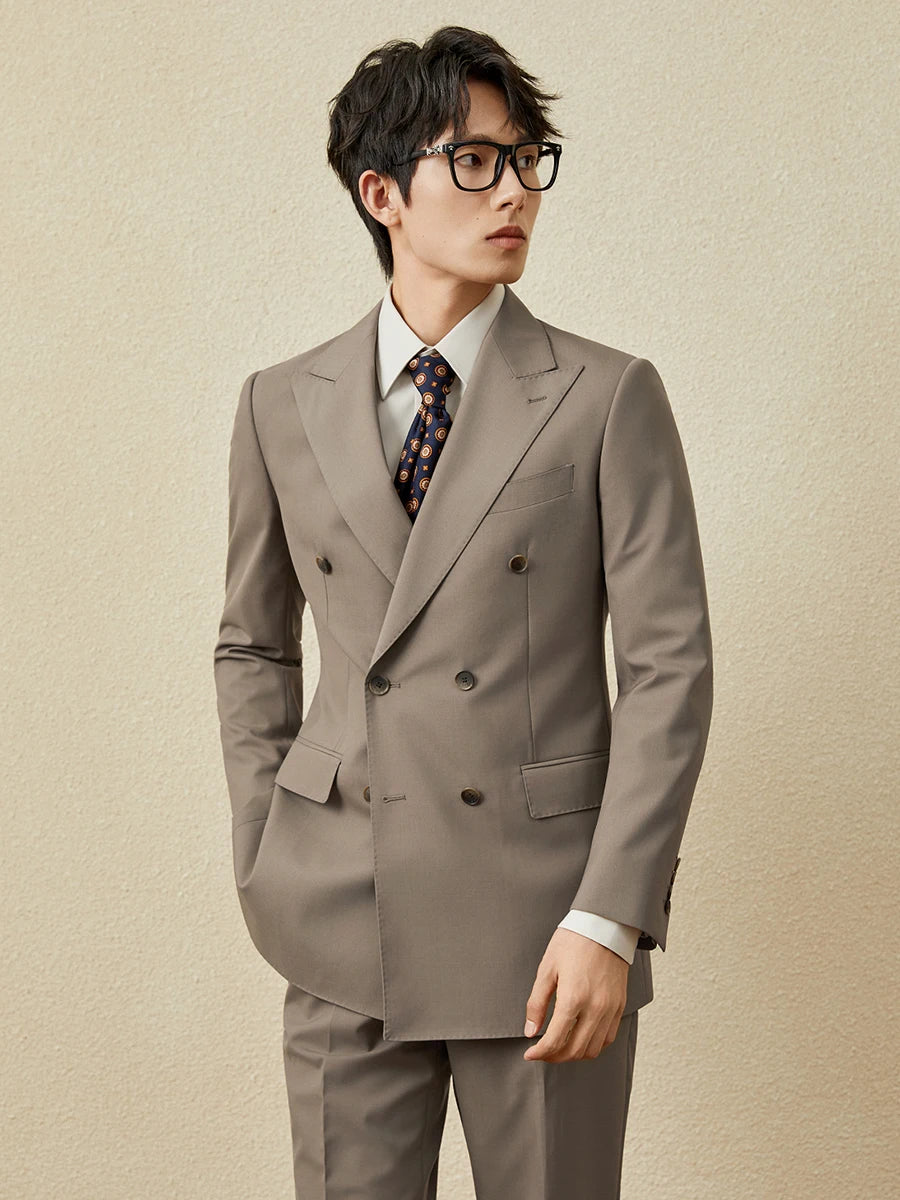 Model in Almond Frost suit gazing to the side, embodying presence in a moment of stillness. From Borcelleclothes.