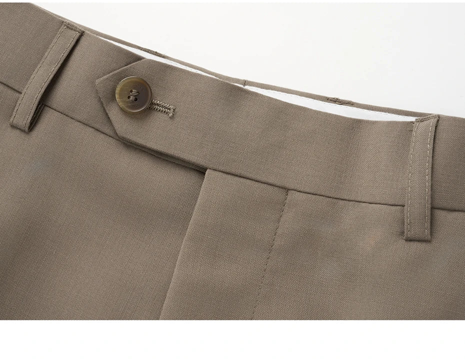 Close-up of the pants waistband with horn button closure in Almond Frost. From Borcelleclothes.