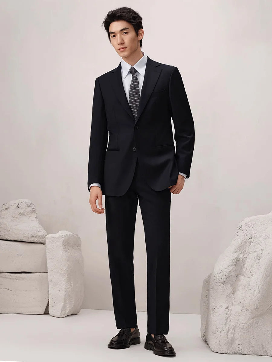 Model in Baltic Sea wool suit stepping forward, emphasizing the cropped trouser length and clean lines. From Borcelleclothes.
