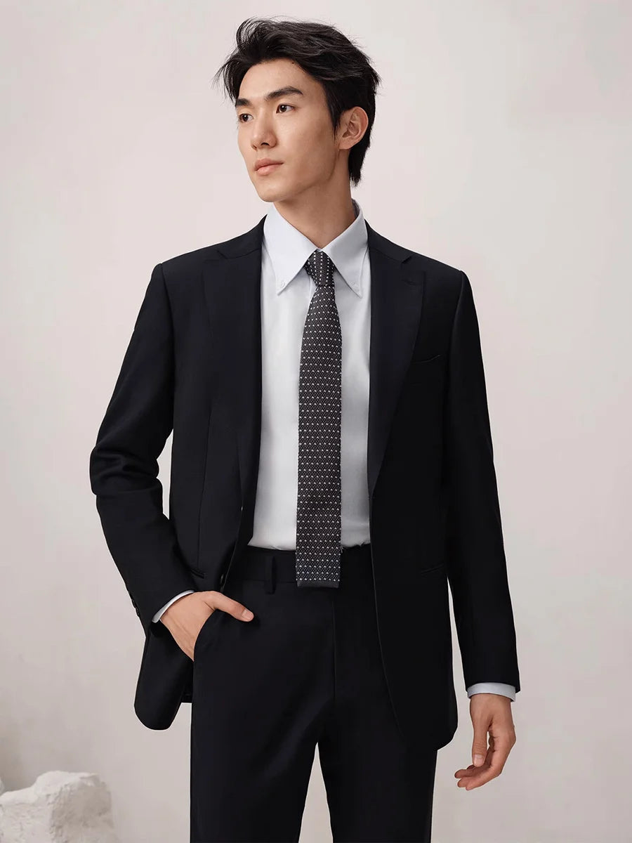 Model wearing the Baltic Sea wool suit with one hand in the trouser pocket, showcasing the slim cropped cut and tailored fit. From Borcelleclothes.