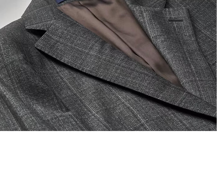 The blazer lapels on the Borcelleclothes Men's Bright Grey 3-Piece Plaid Suit, showcasing the precision tailoring and plaid fabric.
