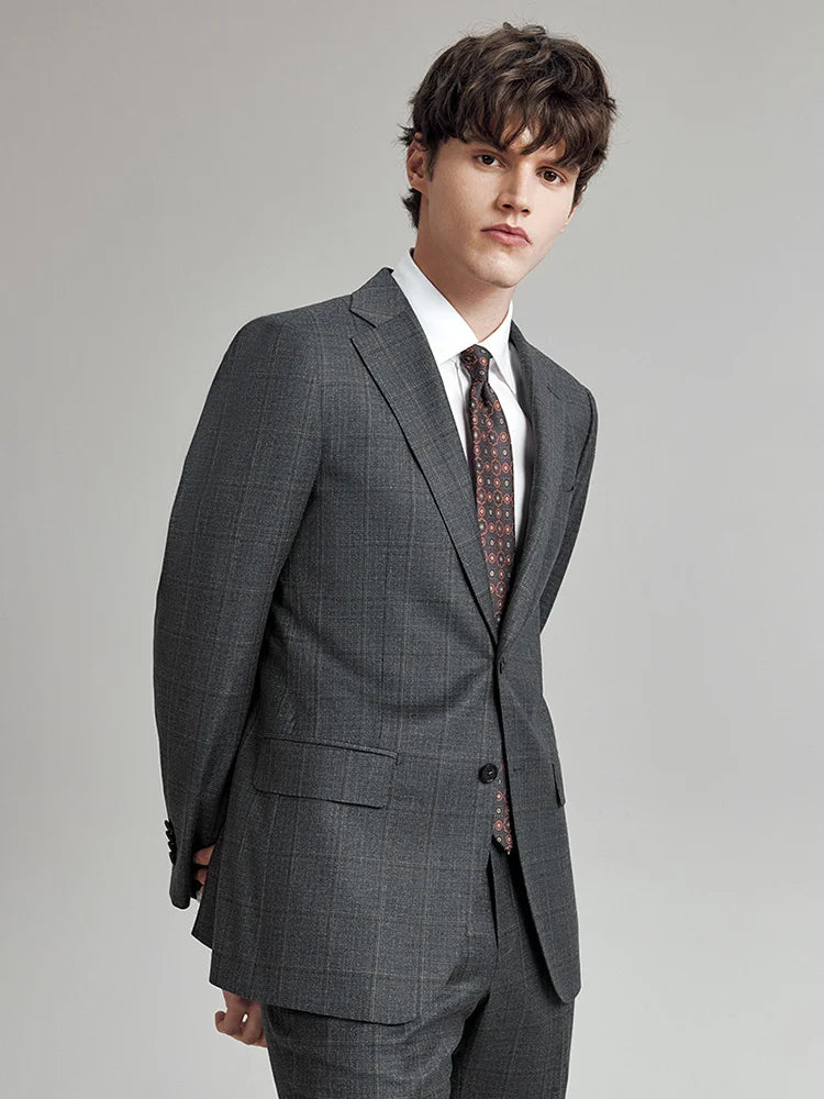 Model wearing the Borcelleclothes Men's Bright Grey 3-Piece Plaid Suit, bent slightly forward, showcasing the tailored fit and refined plaid pattern.