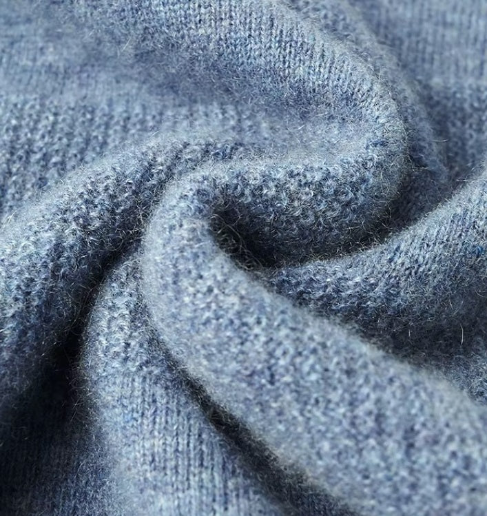 Soft 100% cashmere Men's Crew Neck Sweater in Rock Blue, being held to highlight its luxurious texture and refined quality. From Borcelleclothes.