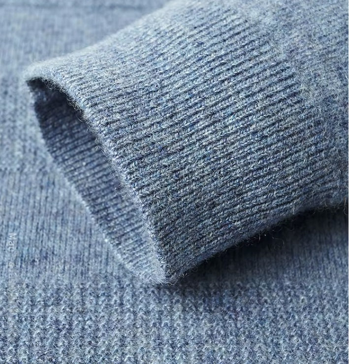 The ribbed sleeve hem on the Men's Cashmere Crew Neck Sweater in Rock Blue, ensuring a snug and elegant finish. From Borcelleclothes.