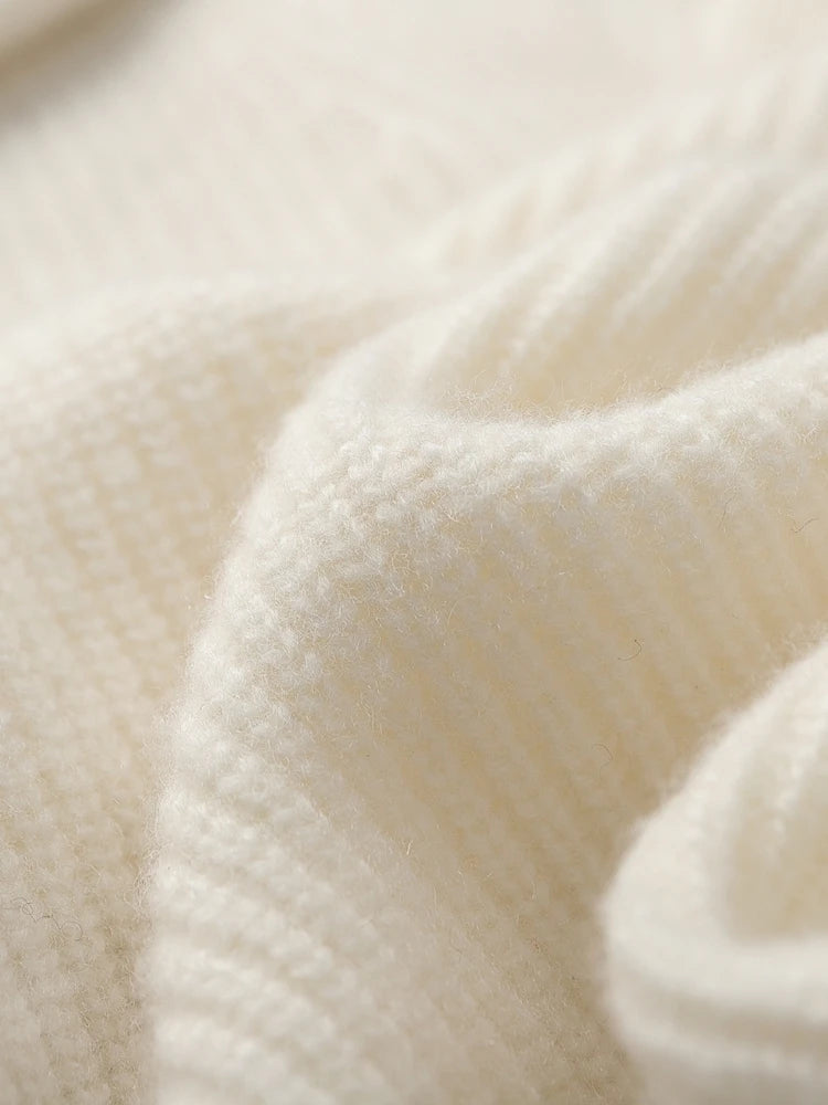 Folded texture of the men’s White Coffee cashmere sweater showing fabric wave — From Borcelleclothes.