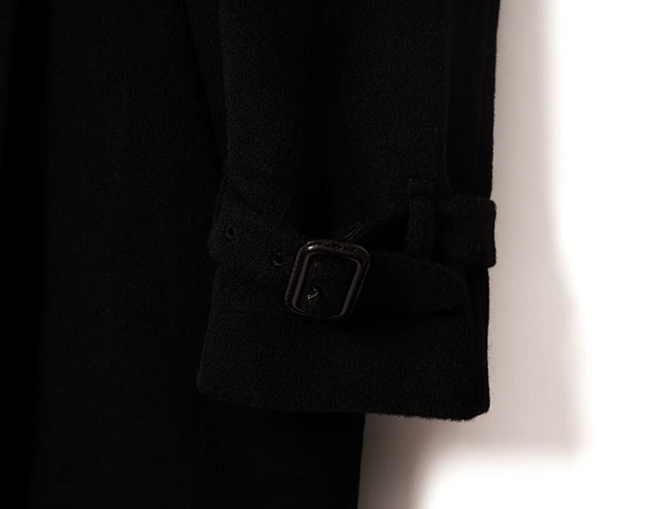 The sleeve end of the Men’s Cashmere Trench Coat in Onyx, highlighting the adjustable belt with a rectangular buckle for a refined touch. From Borcelleclothes.