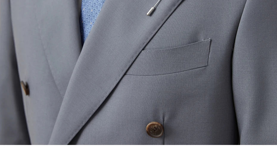 Zoom on Comet blazer’s chest pocket with visible stitchwork and button detail. From Borcelleclothes.