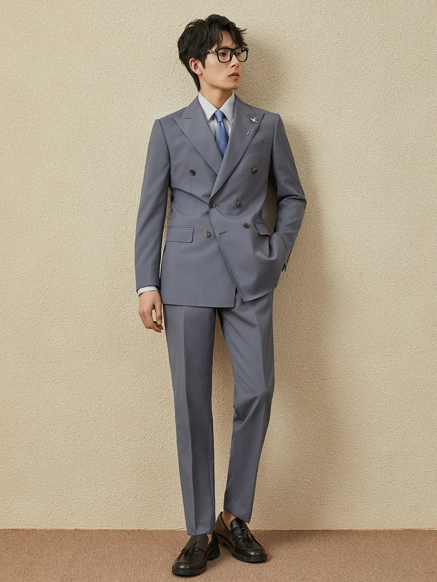 Model in Comet Classical Suit with one hand in pants pocket, blazer sharply tailored. From Borcelleclothes.