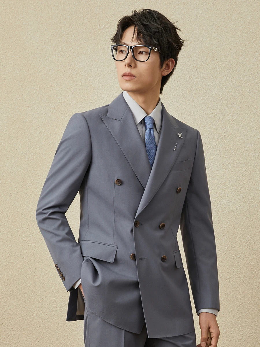 Model in Comet Classical Suit with sideward glance and relaxed pose, hand in pocket. From Borcelleclothes.