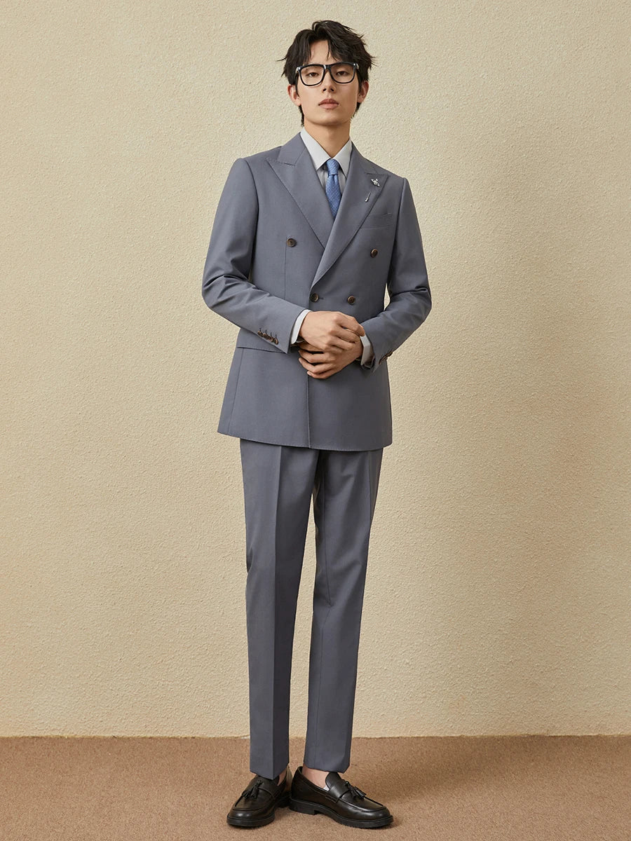 Model adjusting sleeve cuff of the Comet blazer, emphasizing precision tailoring. From Borcelleclothes.