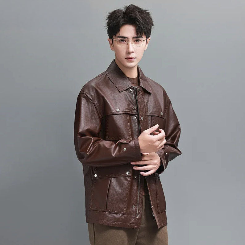 Detail view of the Rose Ebony jacket with the model touching the sleeve end; showcases subtle stitching and snap closure on the cuff. From Borcelleclothes.