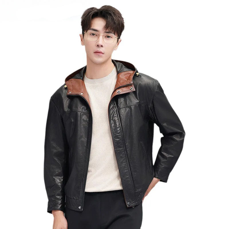 Model wearing men’s cowhide leather jacket in Onyx with Nutmeg accents, unzipped, holding the bottom hem — From Borcelleclothes.