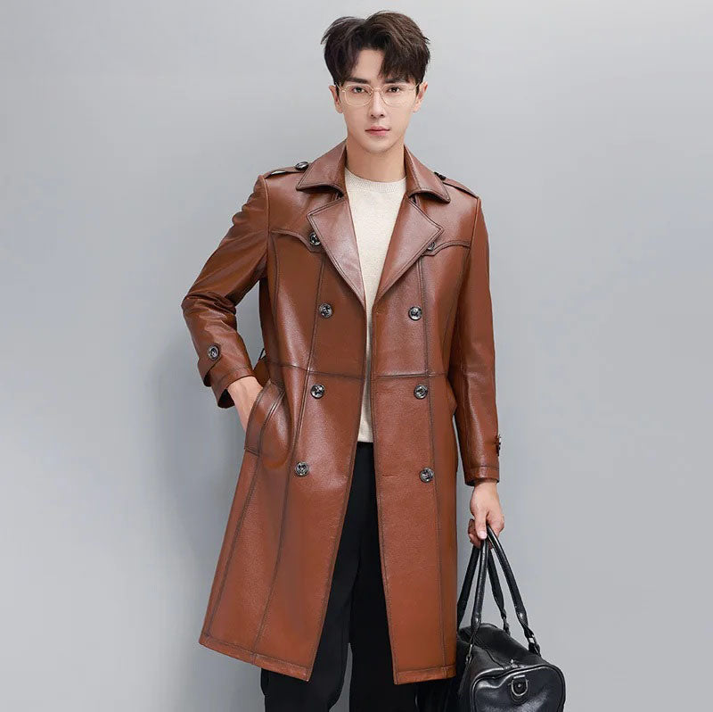 Men’s cowhide leather trench coat in Nutmeg, model holding oversized bag — From Borcelleclothes.