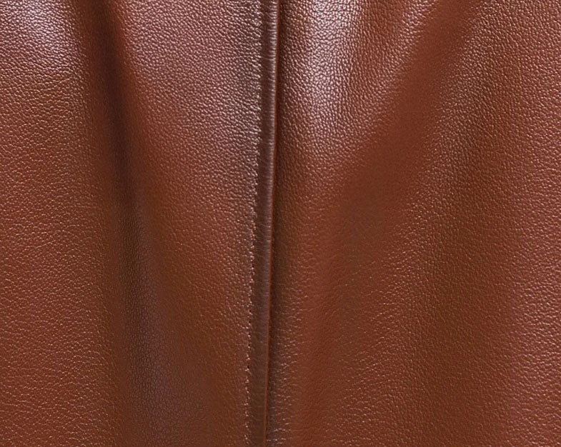 Men’s cowhide leather trench coat in Nutmeg, close-up of leather texture — From Borcelleclothes.