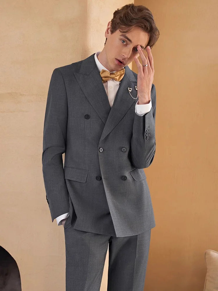 Davy Grey three-piece suit worn by model in a contemplative pose, fingers lightly touching the eyebrow. From Borcelleclothes.