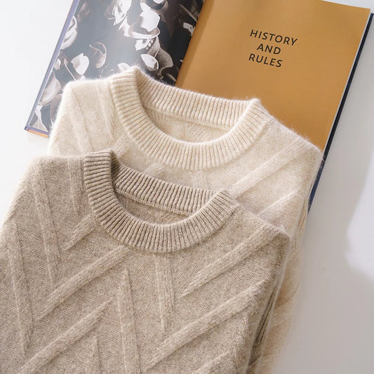 Stacked Men's Dimensional Abstract Sprouts Wool Sweaters in Almond and Sandrift, displayed with a booklet detailing the history and care instructions of premium cashmere. From Borcelleclothes.