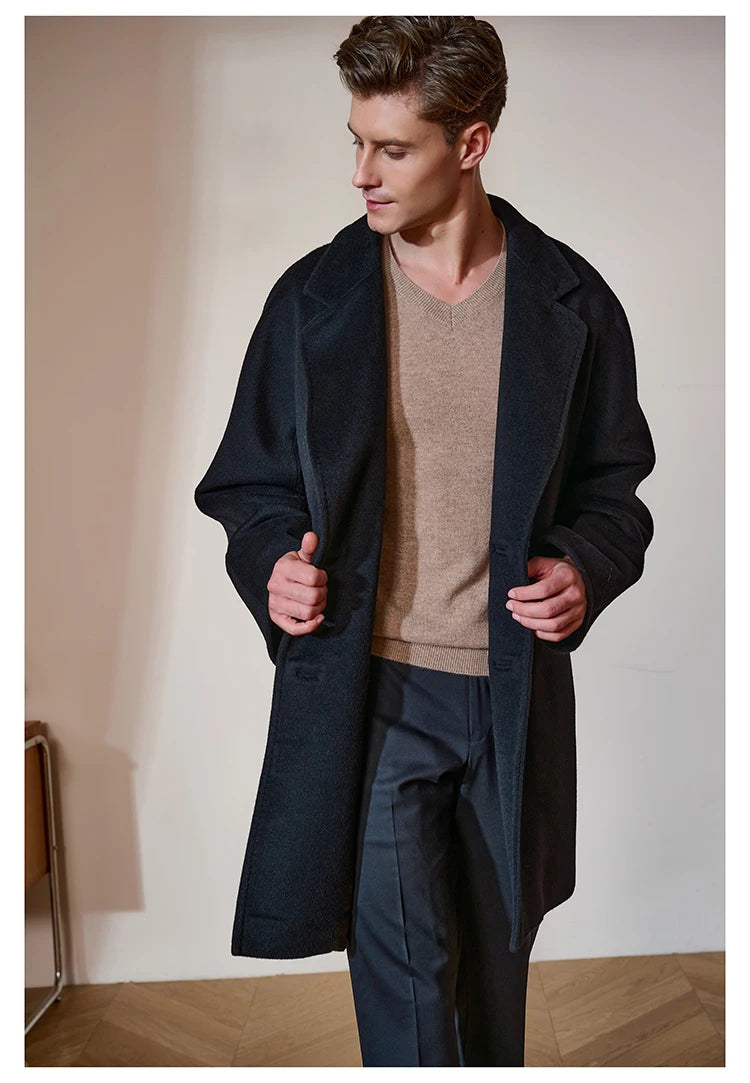 Model in the Black Pearl cashmere coat, gently holding the front edges to show the depth of the fabric’s tone and soft texture. From Borcelleclothes.