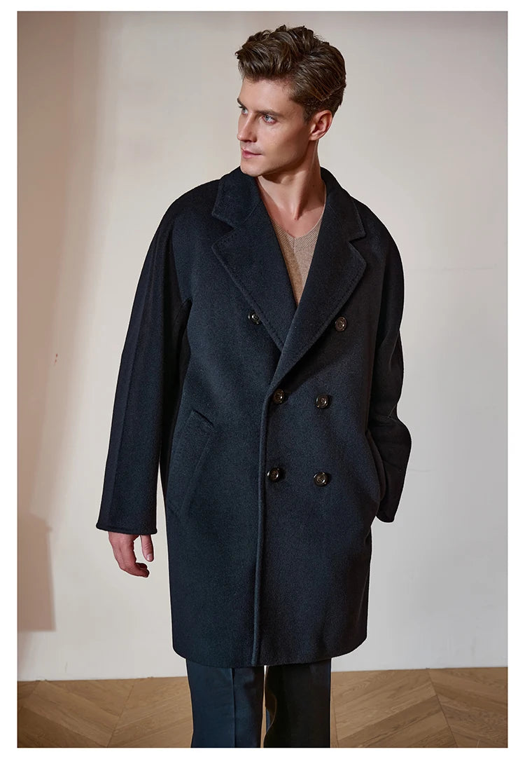 Model wearing the Men’s Double-Breasted Cashmere Coat in Black Pearl, gazing to the side. Showcasing the relaxed drape and modern elegance of the coat. From Borcelleclothes.