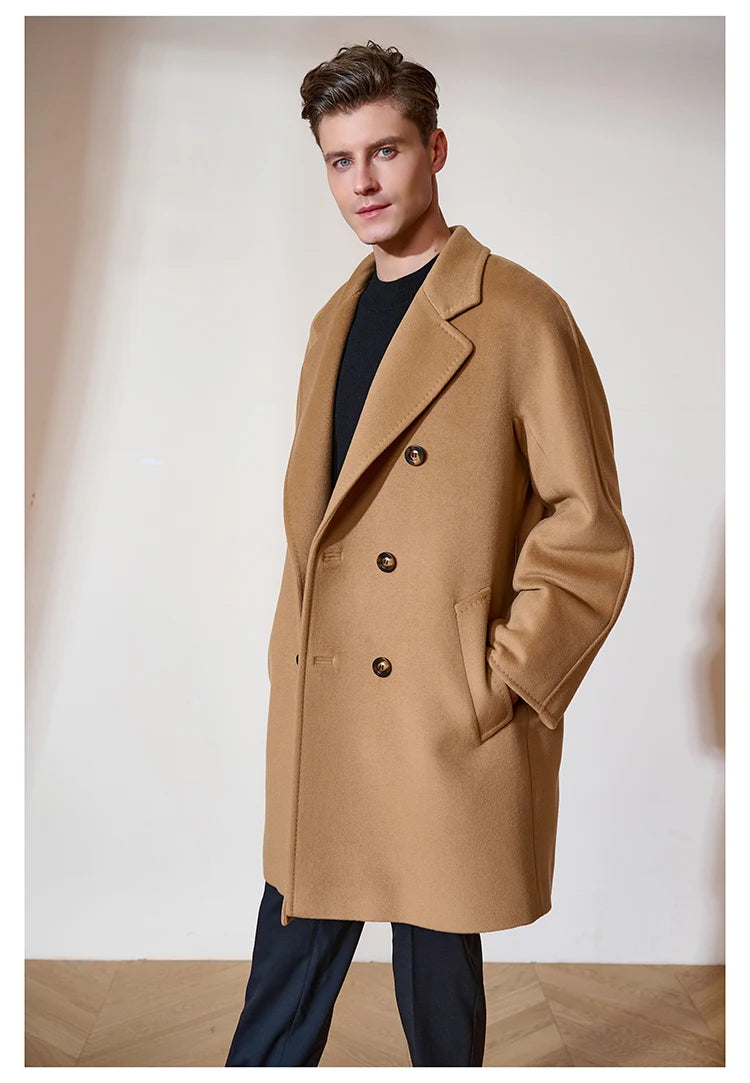 Model in the Men’s Double-Breasted Cashmere Coat in Light Taupe with hands in pockets, highlighting its relaxed fit and contemporary appeal. From Borcelleclothes.